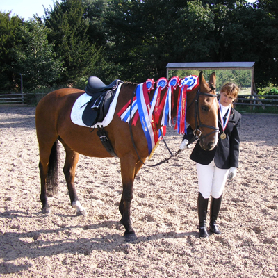 Horse and rider with British Dressage Championship Rosettes