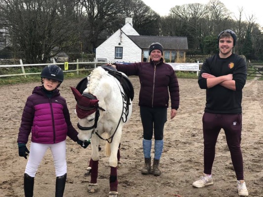 Rider with horse and trainer